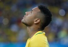 Brazilian footballer Neimeyer looks upwards during game.