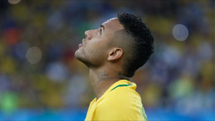 Brazilian footballer Neimeyer looks upwards during game.