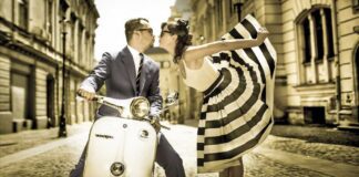 From Italy To Bossa With Love. A well-dressed man kisses a flambouyant women wearing a stunning black and white sun dress hile sitting on a Vespa motorbike on an Italian cobblestone street.
