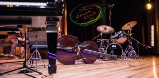 Brazilian jazz concert stage with piano, bass, drums