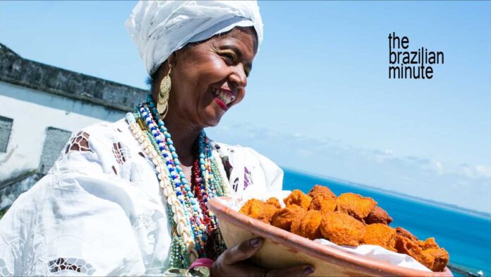 Baiana woman from Bahia holds a woven basket of Acaraje, African Culture in Brazil