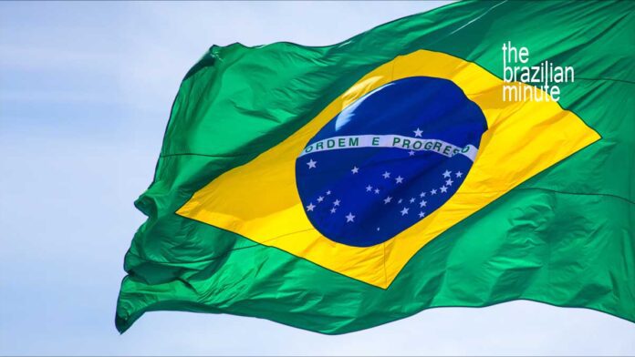 Brazil's National Flag waving in a clear blue sky.