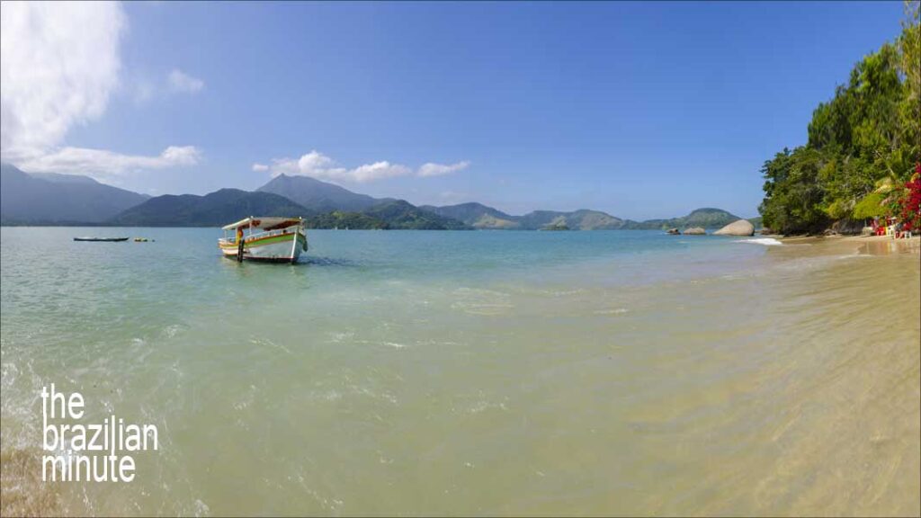 Experience Brazils World Heritage Sites: A fishing boat floats in the tropcail waters near the island of Pelado in Paraty,