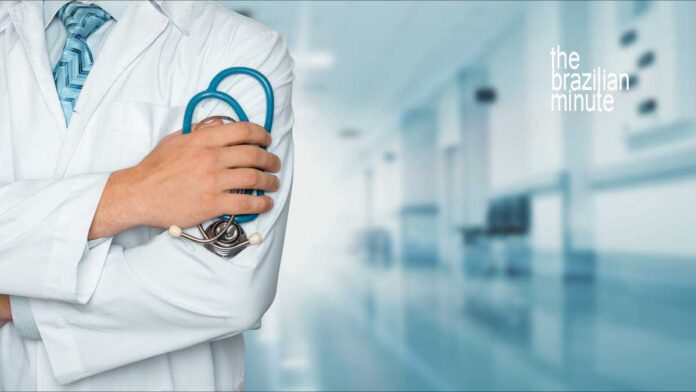 Brazil-US Cooperation in Health Sciences. Medical worker in white lab coat holding stethescope.