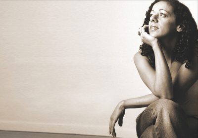 Relaxing Brazilian Music Streaming Channels. Brazilian Jazz Instrumentals. A Brazilian women poses while seated in a casual way.