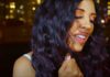 Cecy Santana's video and lyrics capture Sao Paulo's positivity. Brazilian singer performing in front of gold-hued city lights at night.