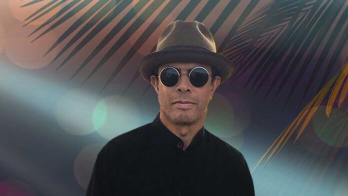 Gregory Abbotts Whisper The Words. The R&B singer wearing trendy sunglasses and stylish hat in front of a tropcial backdrop.
