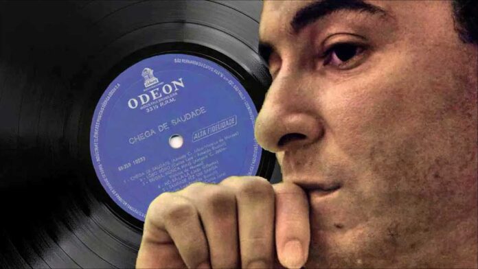A world without Bossa Nova. Brazilian singer Joao Gilberto in profile with his debut record album in the background